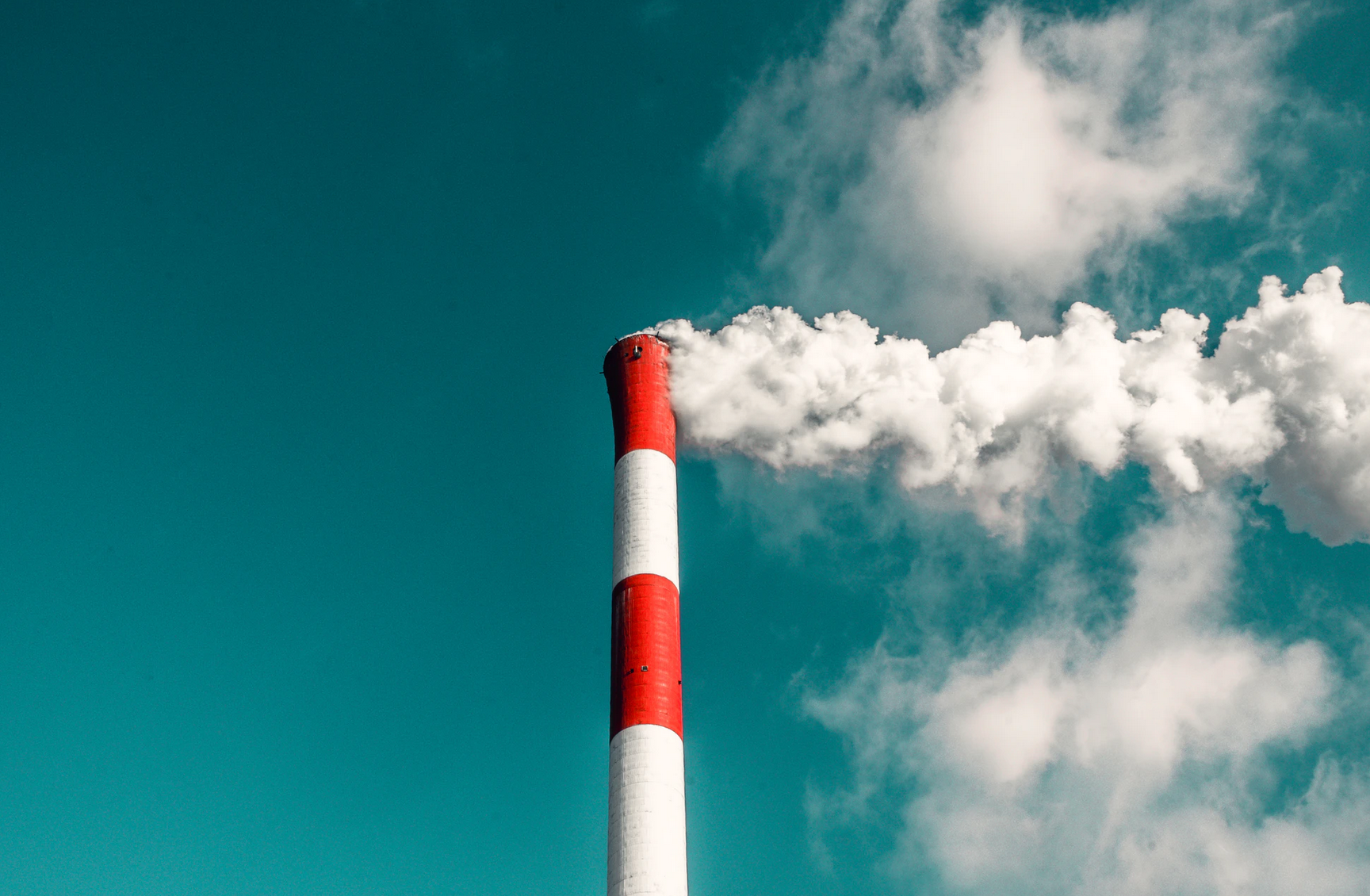 red and white chimney against a blue sky